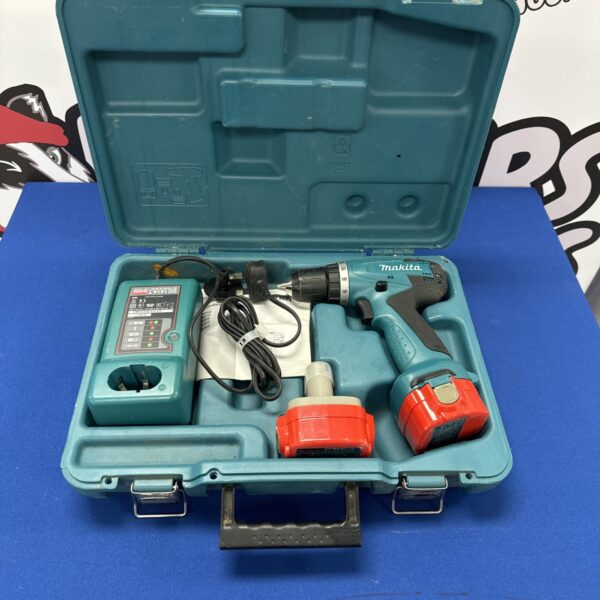Makita 6381DWDE cordless drill with charger in open case.