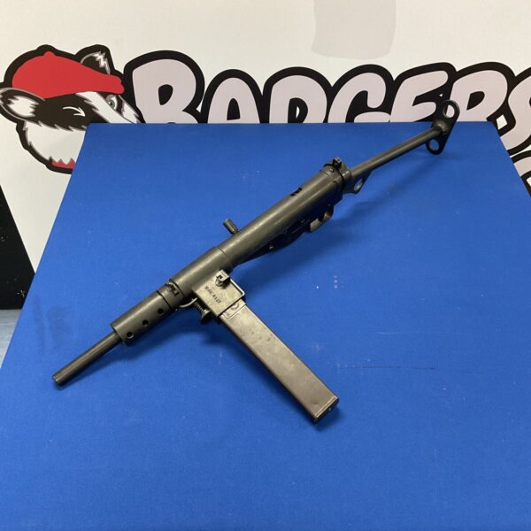 Detailed replica Sten Gun MkII on a blue surface.