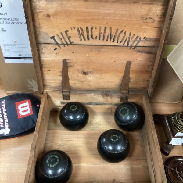 Vintage wooden box containing a set of lawn bowls.