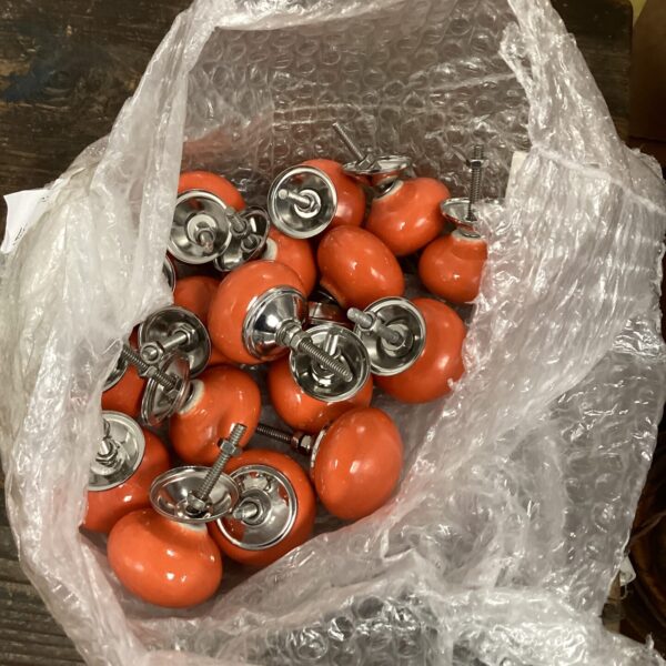 Vintage cream ceramic cupboard knobs with metal bases.