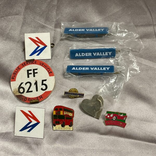Vintage bus driver badges with number 6215, transport collectables.