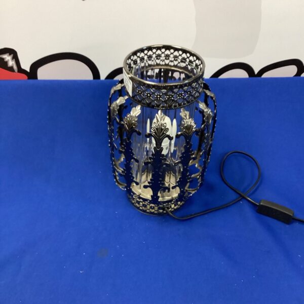 Intricate ornate metal table lamp with detailed design.