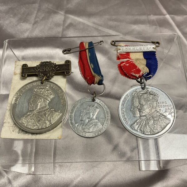 Vintage coronation medals featuring King Edward VII and King George V.
