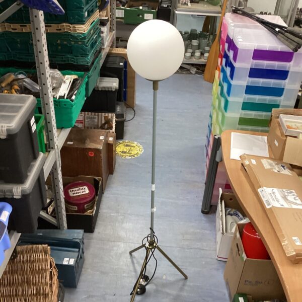 Vintage metal standard lamp with spherical shade and tripod base.