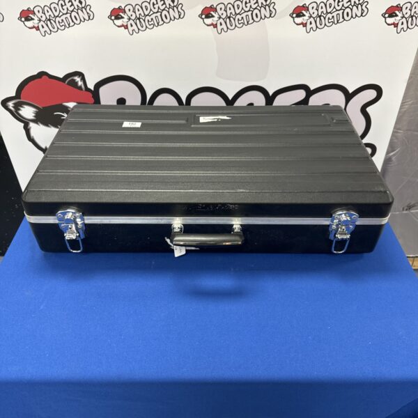 Front view of a black plastic flight case with a key lock.