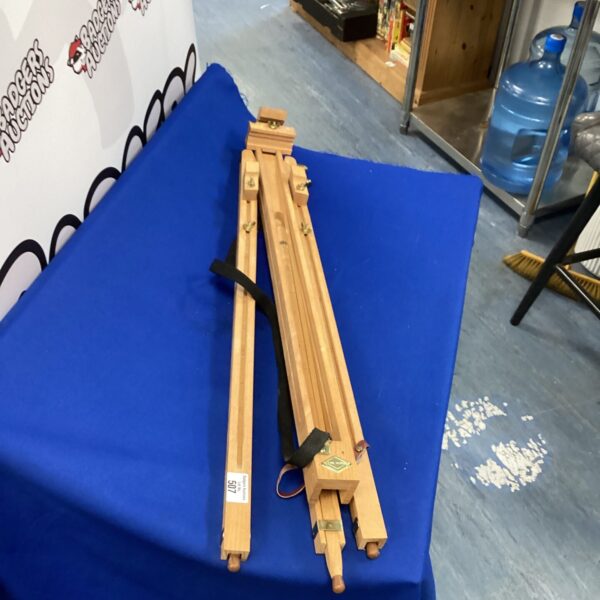 Vintage wooden artist easel with tripod base, ideal for painting.