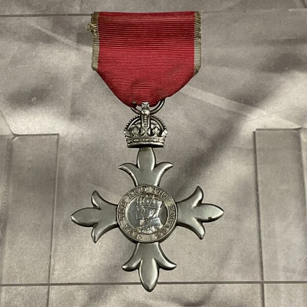 Silver Order of the British Empire MBE medal with red ribbon.