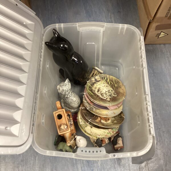 Collection of vintage cat figurines and decorative plates.