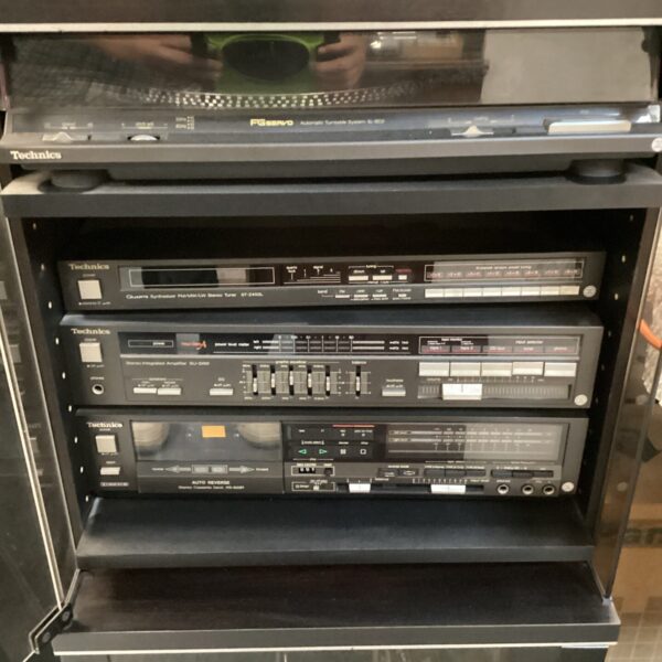 Vintage Technics hi-fi system with turntable and speakers.
