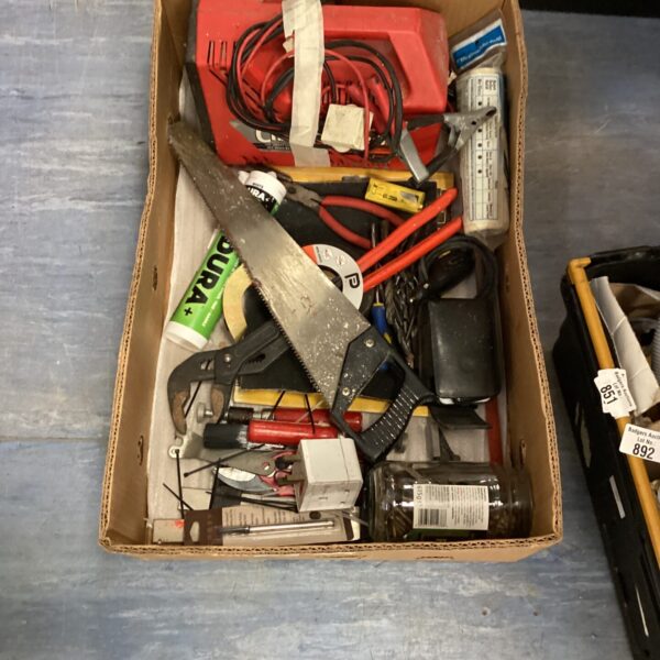 Mixed tool lot with battery charger and various hand tools.