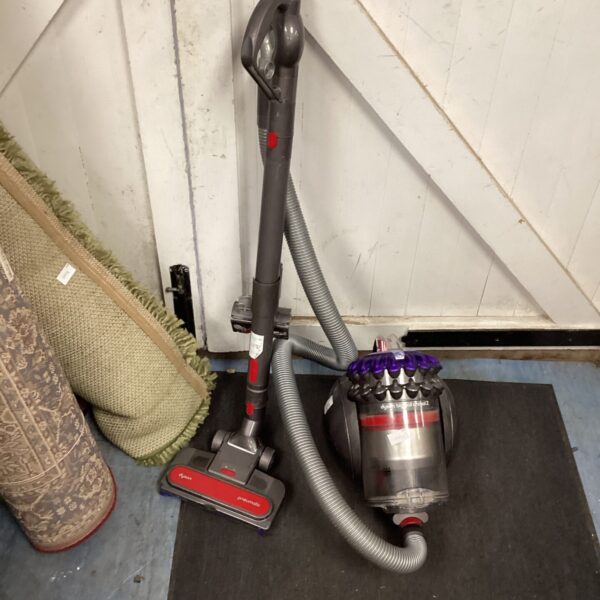 Upright Dyson Ball vacuum cleaner with hose attachment.