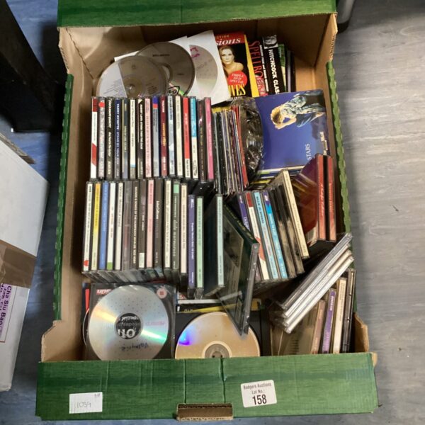Assorted music CDs including Simply Red and Billie Spears in a tray.