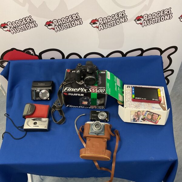 Group of vintage digital cameras, including Panasonic Lumix and Fujifilm Finepix.