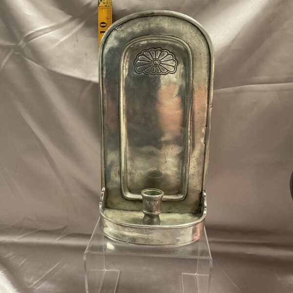 Vintage pewter wall sconce with embossed detailing.