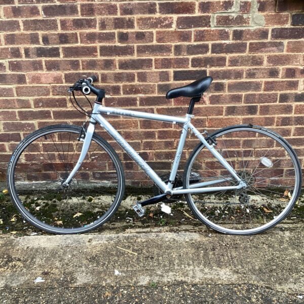 Silver Specialized Sirrus racer bike, side view.