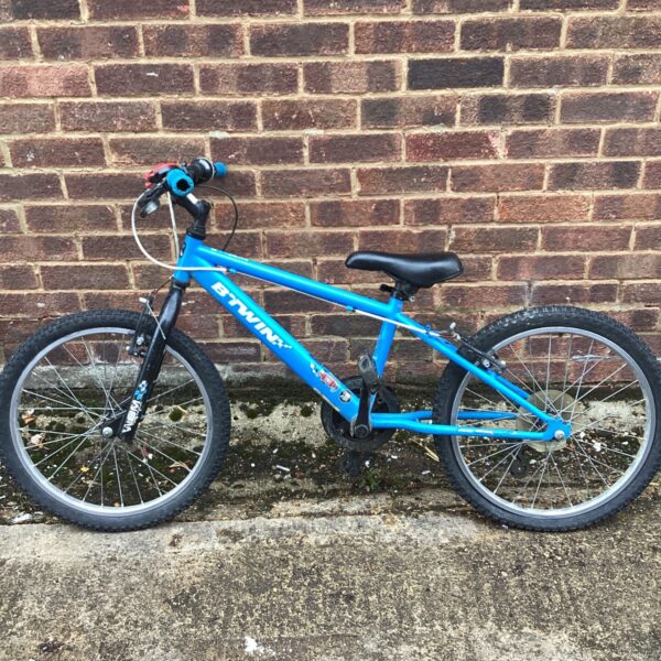 Blue Btwin Racing Boy 300 childs bicycle, side view.