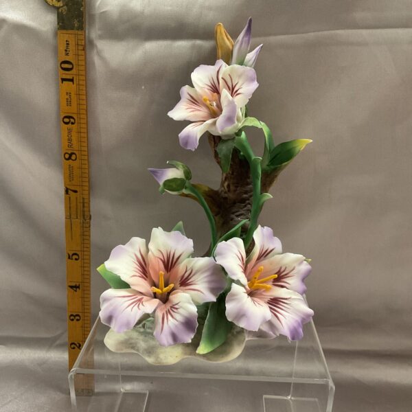 Vintage Capodimonte floral figurine with delicate porcelain lilies.