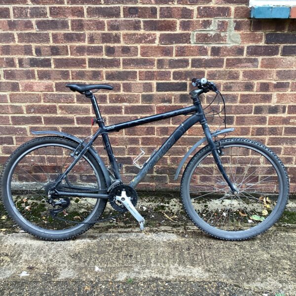 Side view of a vintage Specialized HRXC adult mountain bike.