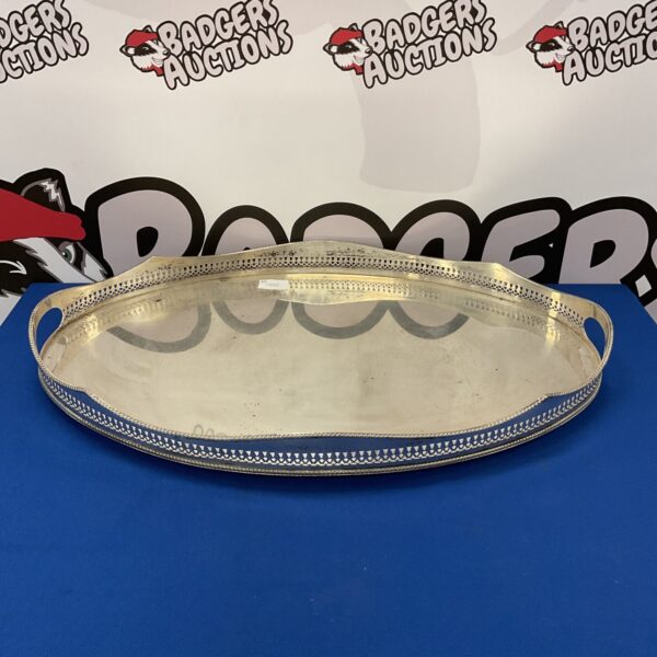 Ornate large silver serving tray with raised rim.
