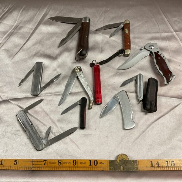 Vintage pocket knife lot with diverse handles and blades.