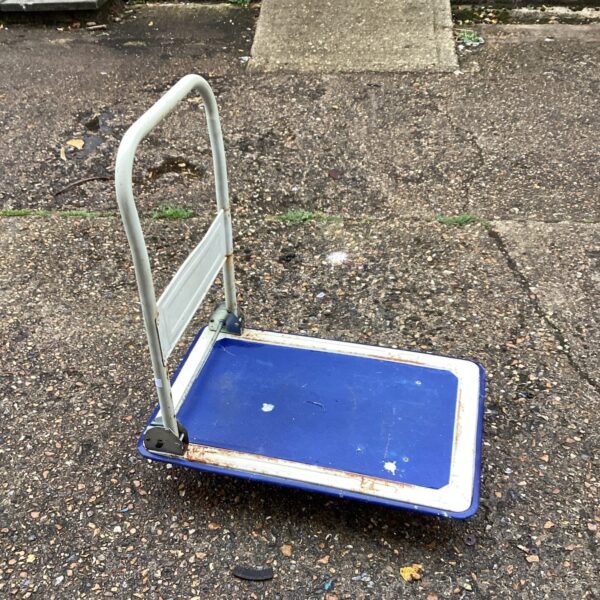 Vintage blue metal folding dolly trolley for utility use.