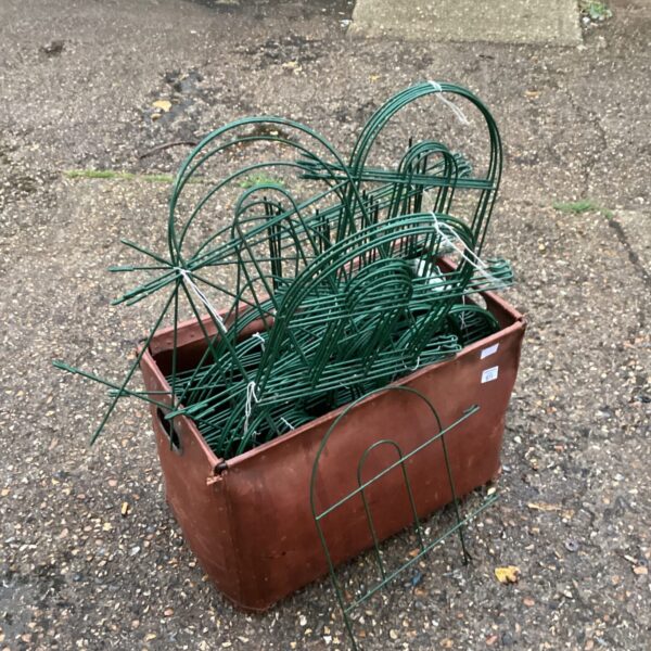 Metal lawn edging fence in a box, ready for garden use.