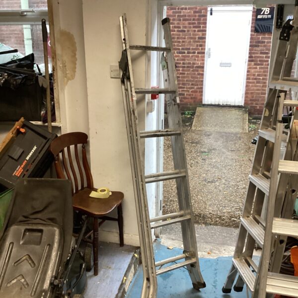 Used aluminium six-rung step ladder in a garage setting.