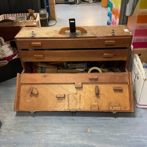 Vintage wooden tool box with drawers, ideal for workshop storage.