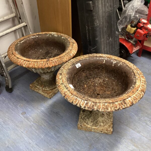 Antique Victorian cast iron urn planters for garden display.