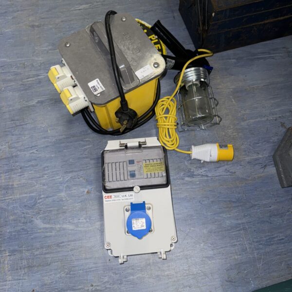 Yellow 110v transformer block with attached site light and circuit breaker.