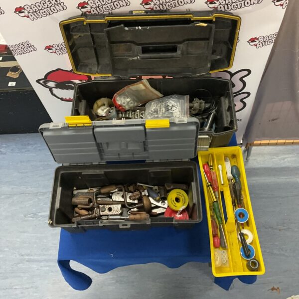 Mixed tool boxes with assorted hand tools and hardware.