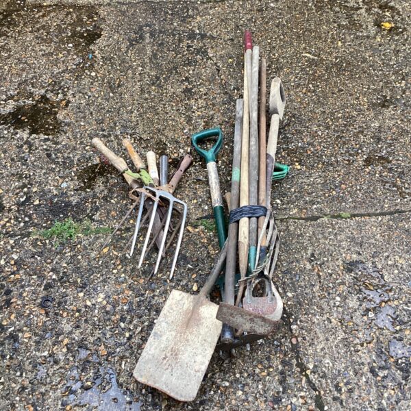 Vintage garden tool lot with spade and fork.