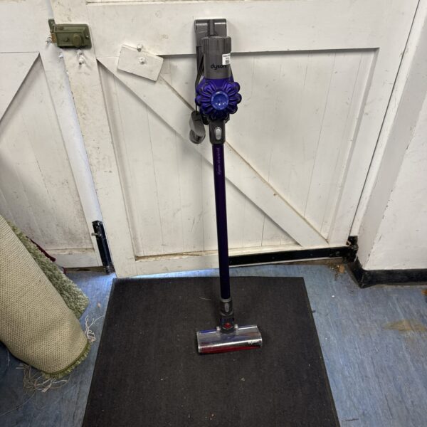 Dyson V6 Animal cordless vacuum cleaner in a home setting.