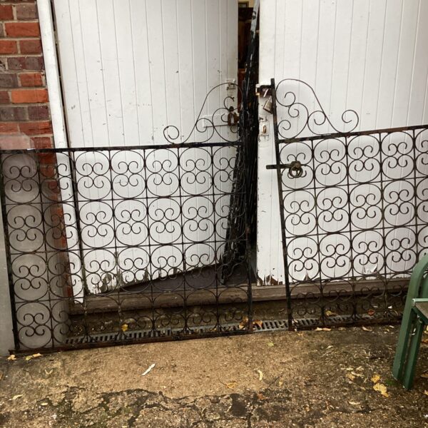Ornate antique cast iron gates with floral design.