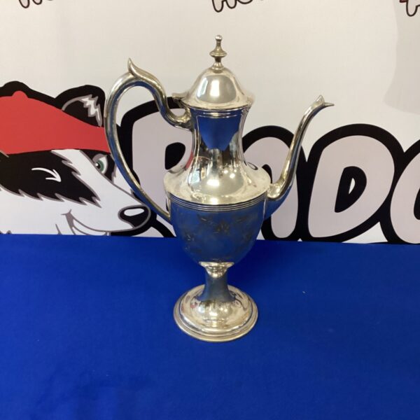 Ornate antique silverplate claret jug for serving drinks.