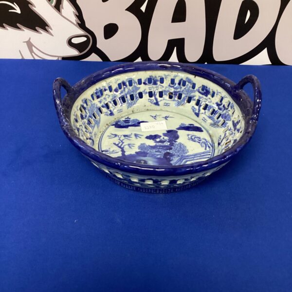 Vintage ironstone fruit bowl with blue transferware landscape.