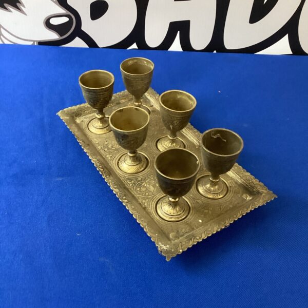 Set of six vintage Indian brass goblets on a tray.