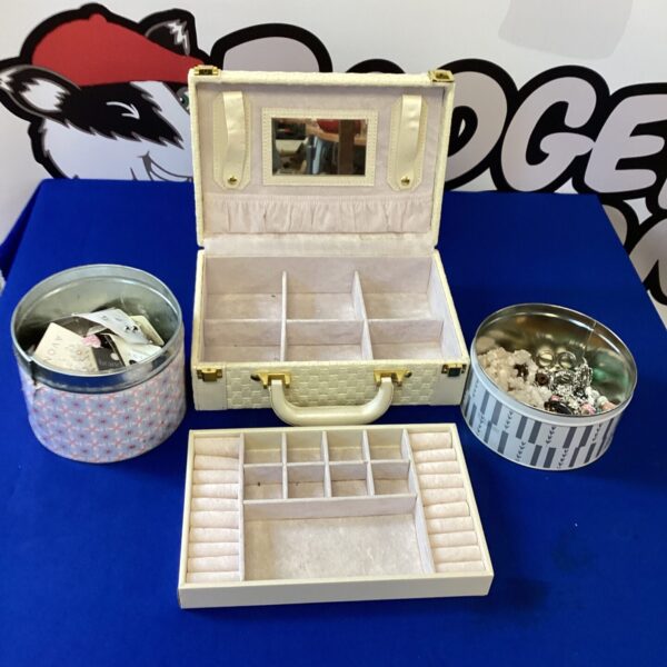 Pink vintage jewellery box filled with costume jewellery.