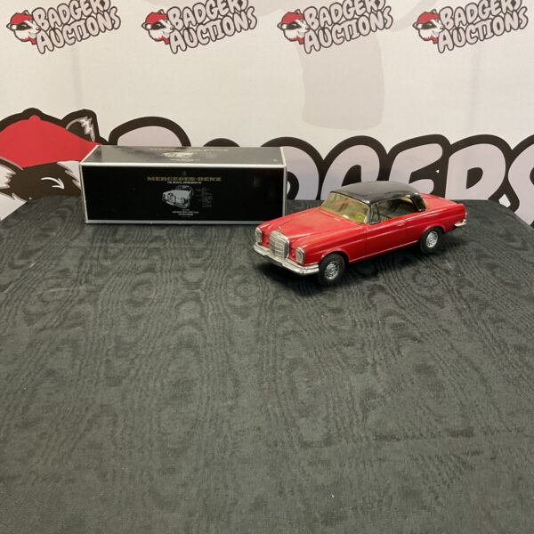Red Mercedes Benz diecast model car, classic revival impression.