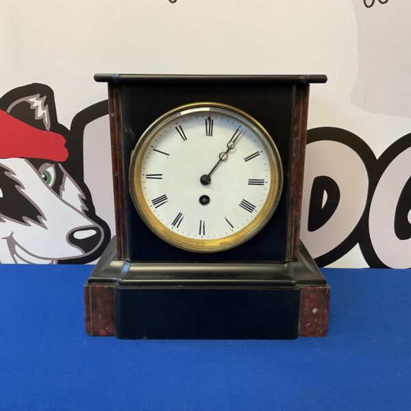 Antique slate mantle clock with marble pillars and Roman numerals.