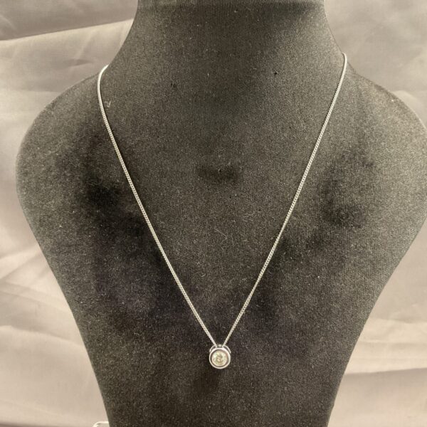 Close-up of 9ct white gold diamond pendant necklace.