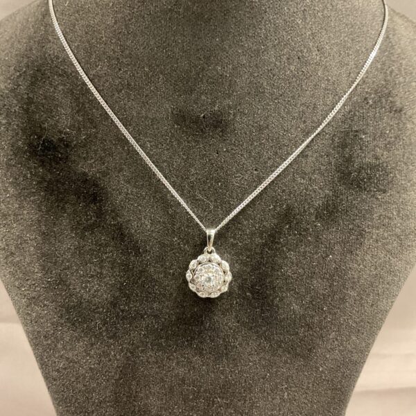 Silver stone cluster necklace on a white background.