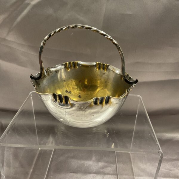 Antique silver plate bonbon dish with twisted handle.