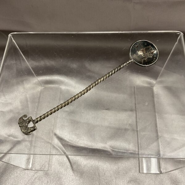 Antique silver half rupee coin spoon with twisted handle.