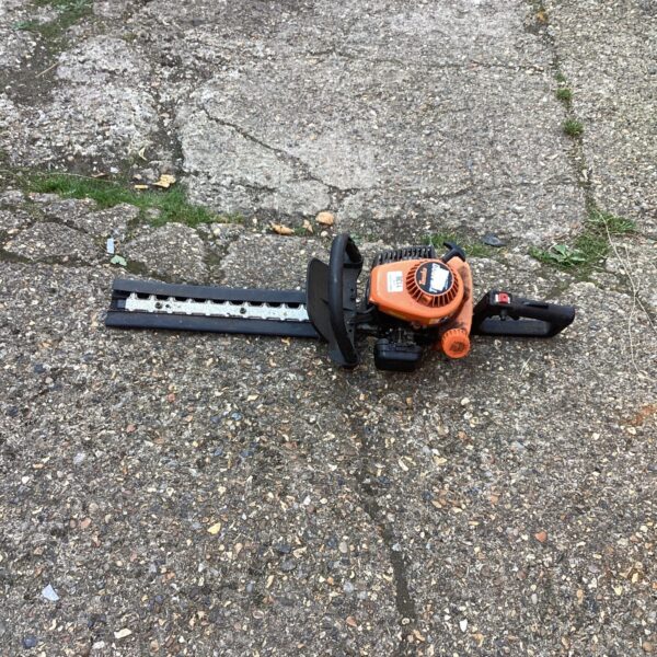 Vintage electric hedge trimmer for garden landscaping and shrub maintenance.