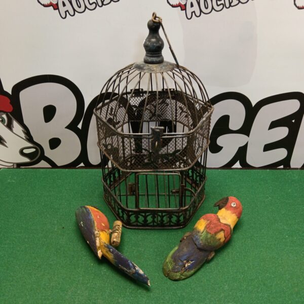 Vintage bird cage with three colourful wooden birds inside.
