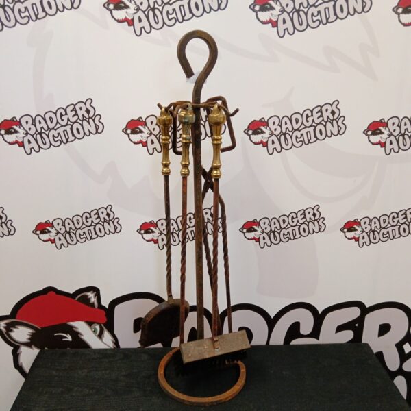 Antique wrought iron fireplace companion set with ornate detailing.