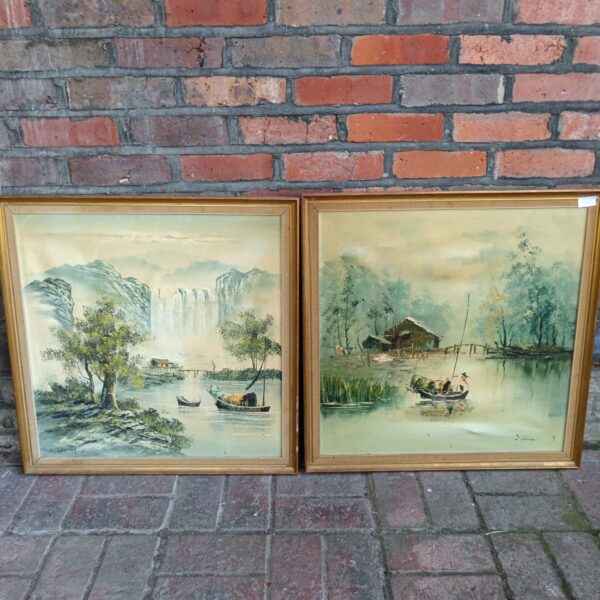 Pair of signed oriental oil paintings depicting fishing boats.