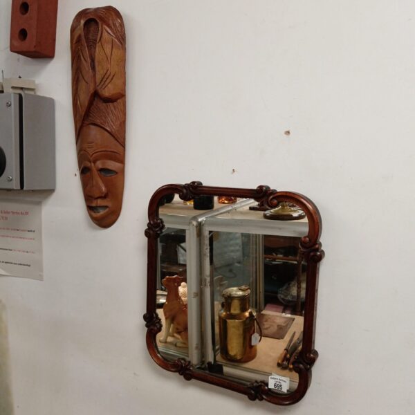 Vintage Art Nouveau mirror with African mask displayed.