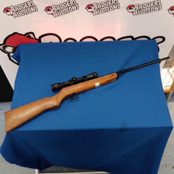 Vintage BSA Meteor air rifle with scope, a classic .22 airgun.